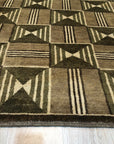 Sumptuous Giselle Brown Hand Knotted Wool Rug, showcasing a rich brown palette and intricate hand-knotted construction, nestled within a warmly lit interior space.