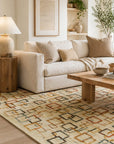 Sandstone Serenity Beige Handmade Wool Ningxia Rug styled in a serene airy living room with cream linen sofa and natural wood accents - area rug lifestyle photo