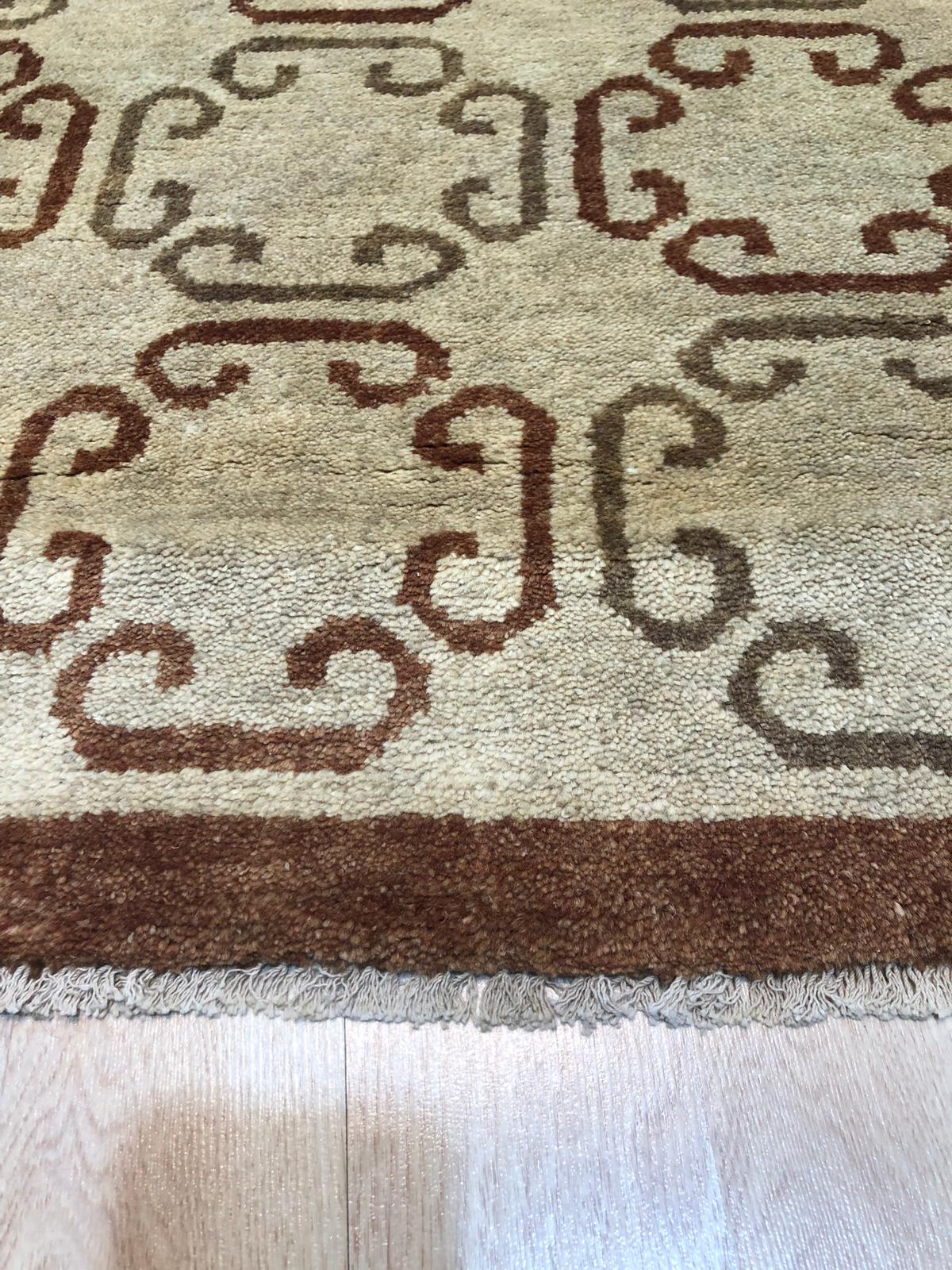 Louie Vibrant Brown Hand Knotted Wool Rug, showcasing warm, earthy tones and intricate hand-knotted details, softening a modern living room with hardwood floors and a minimalist aesthetic.