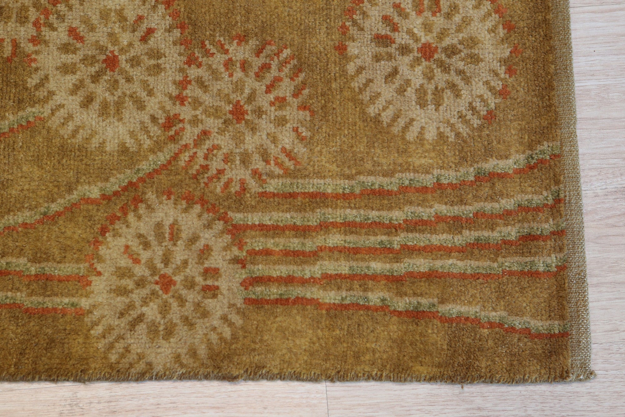 Lila Jasmine Brown Hand Knotted Wool Rug, featuring a warm, neutral palette with intricate detailing, displayed in a room setting.