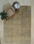 Nadia Mira Beige Nan Rug displayed in a living room setting, its subtle geometric pattern blending seamlessly with neutral furniture; the beige nan material adds warmth and texture to the space.