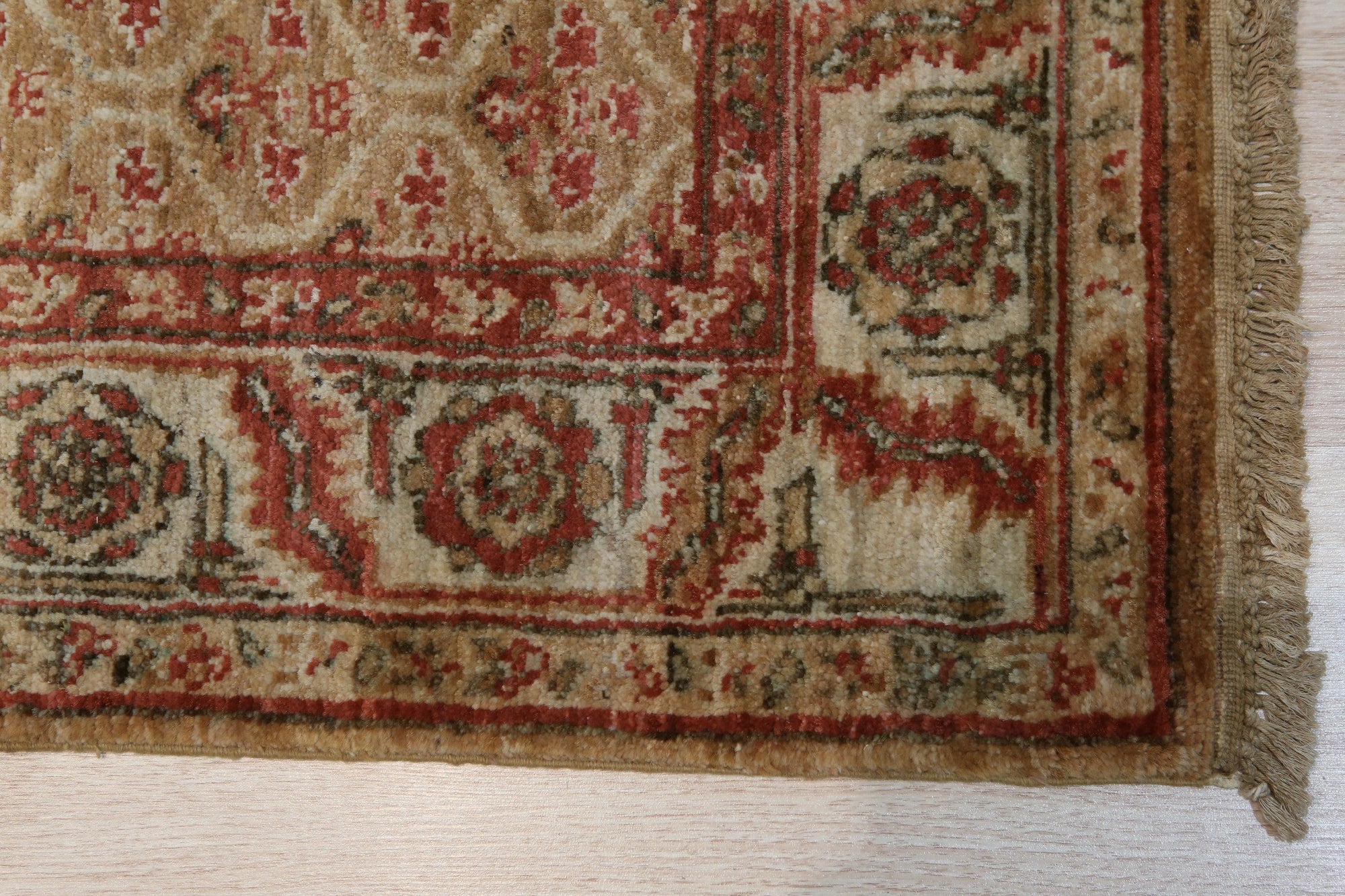Giselle Zinnia Brown Hand Knotted Wool Rug displayed in a living room setting, its intricate floral pattern and warm brown tones complementing neutral furniture and creating a cozy, inviting atmosphere.