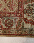 Giselle Zinnia Brown Hand Knotted Wool Rug displayed in a living room setting, its intricate floral pattern and warm brown tones complementing neutral furniture and creating a cozy, inviting atmosphere.