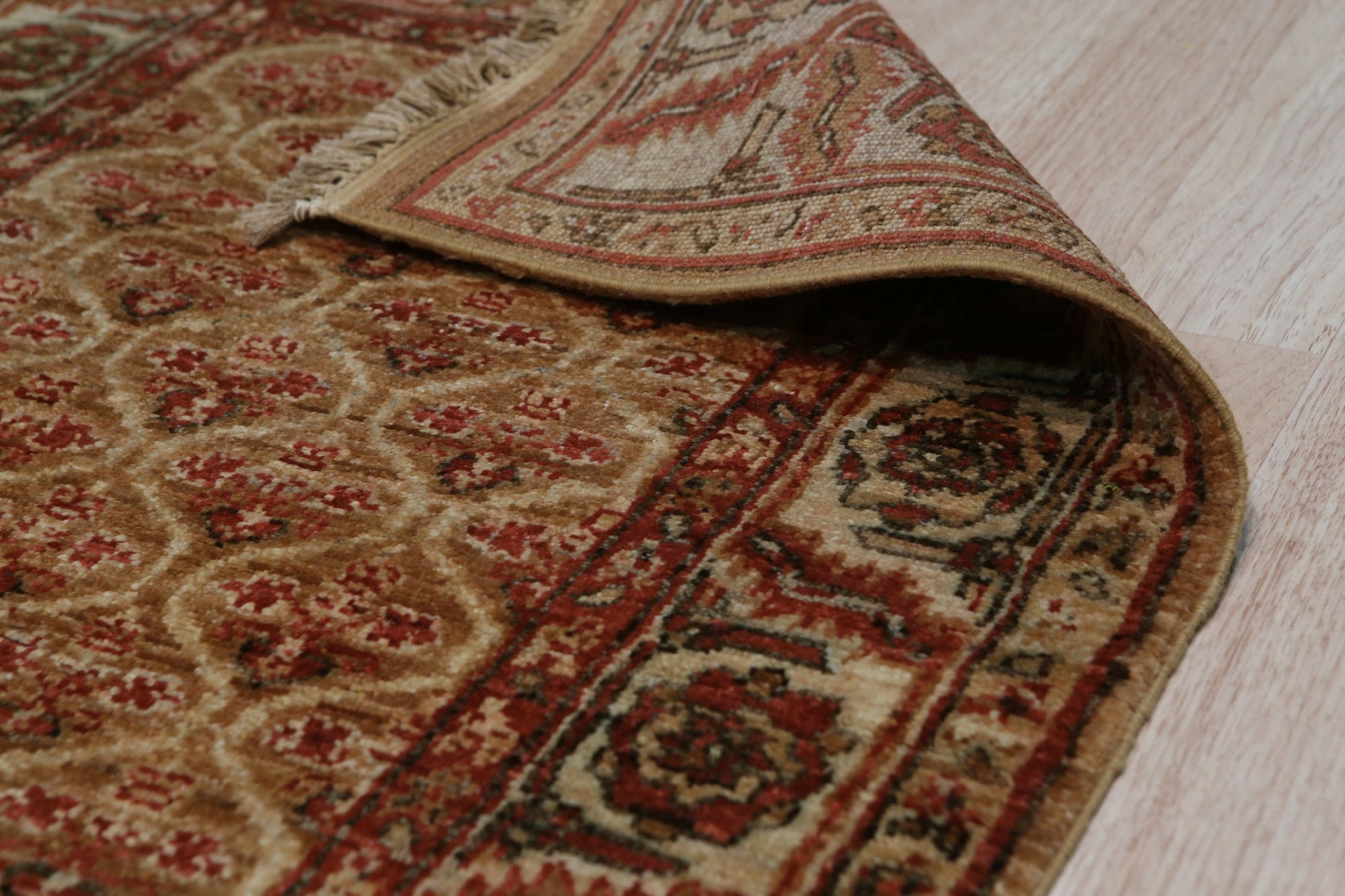 Giselle Zinnia Brown Hand Knotted Wool Rug, warm brown tones and intricate floral patterns lend a cozy elegance to this wool rug, showcasing its hand-knotted construction.
