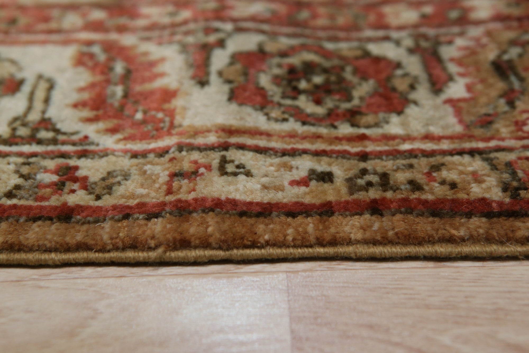 Giselle Zinnia Brown Hand Knotted Wool Rug displayed in a well-lit living room, showcasing its intricate floral design and warm, earthy tones.