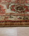Giselle Zinnia Brown Hand Knotted Wool Rug displayed in a well-lit living room, showcasing its intricate floral design and warm, earthy tones.