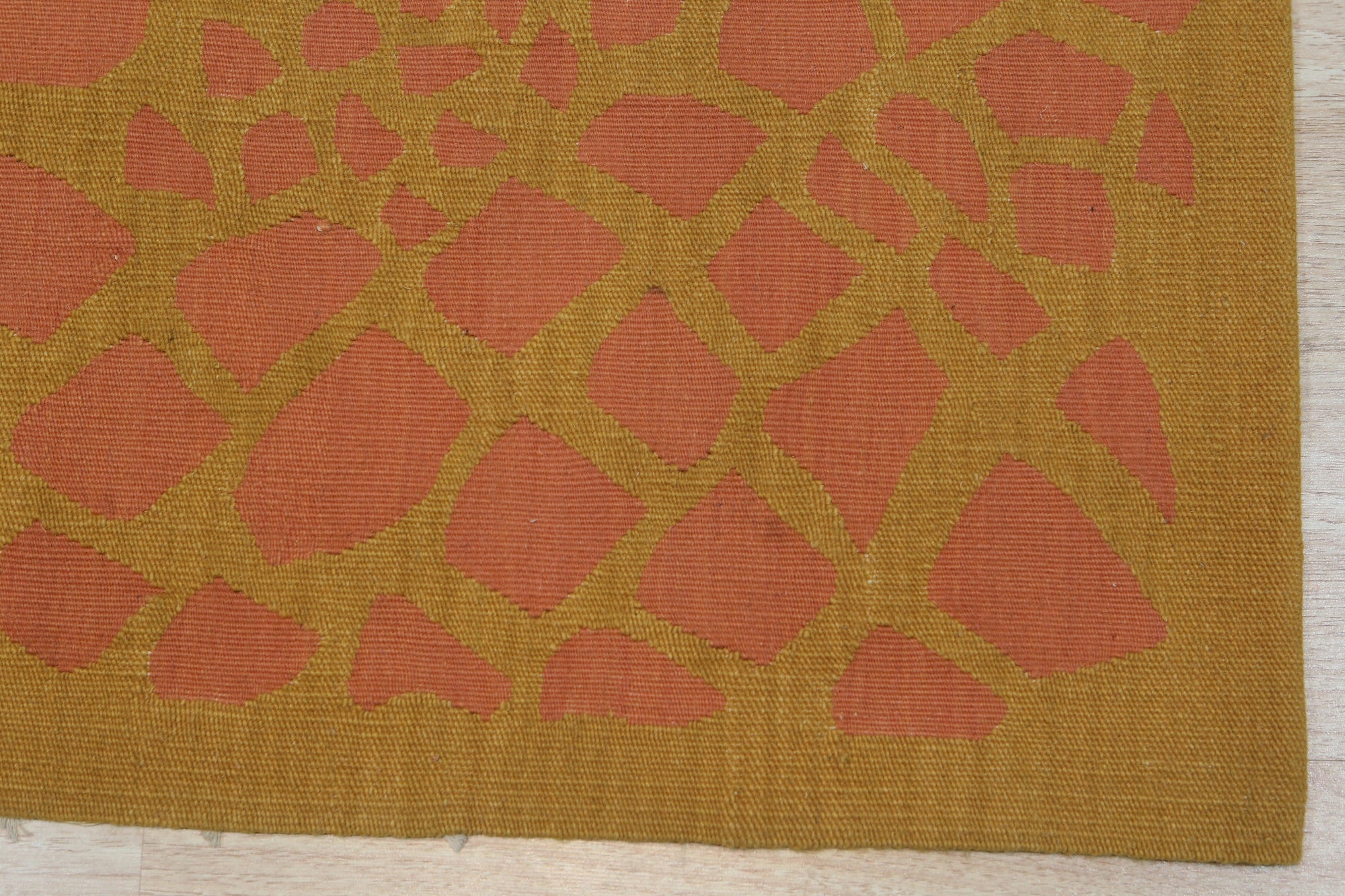Amara Ruby Rust Flatweave Wool Rug, showcasing warm rust and ruby tones in a detailed flatweave construction, displayed in a room setting with complementing furniture and decor.