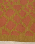 Amara Ruby Rust Flatweave Wool Rug, showcasing warm rust and ruby tones in a detailed flatweave construction, displayed in a room setting with complementing furniture and decor.