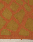 Artisan Handcrafted Rust Flatweave Wool Rug, showcasing a warm rust hue and subtle texture in a bright, modern living room setting.