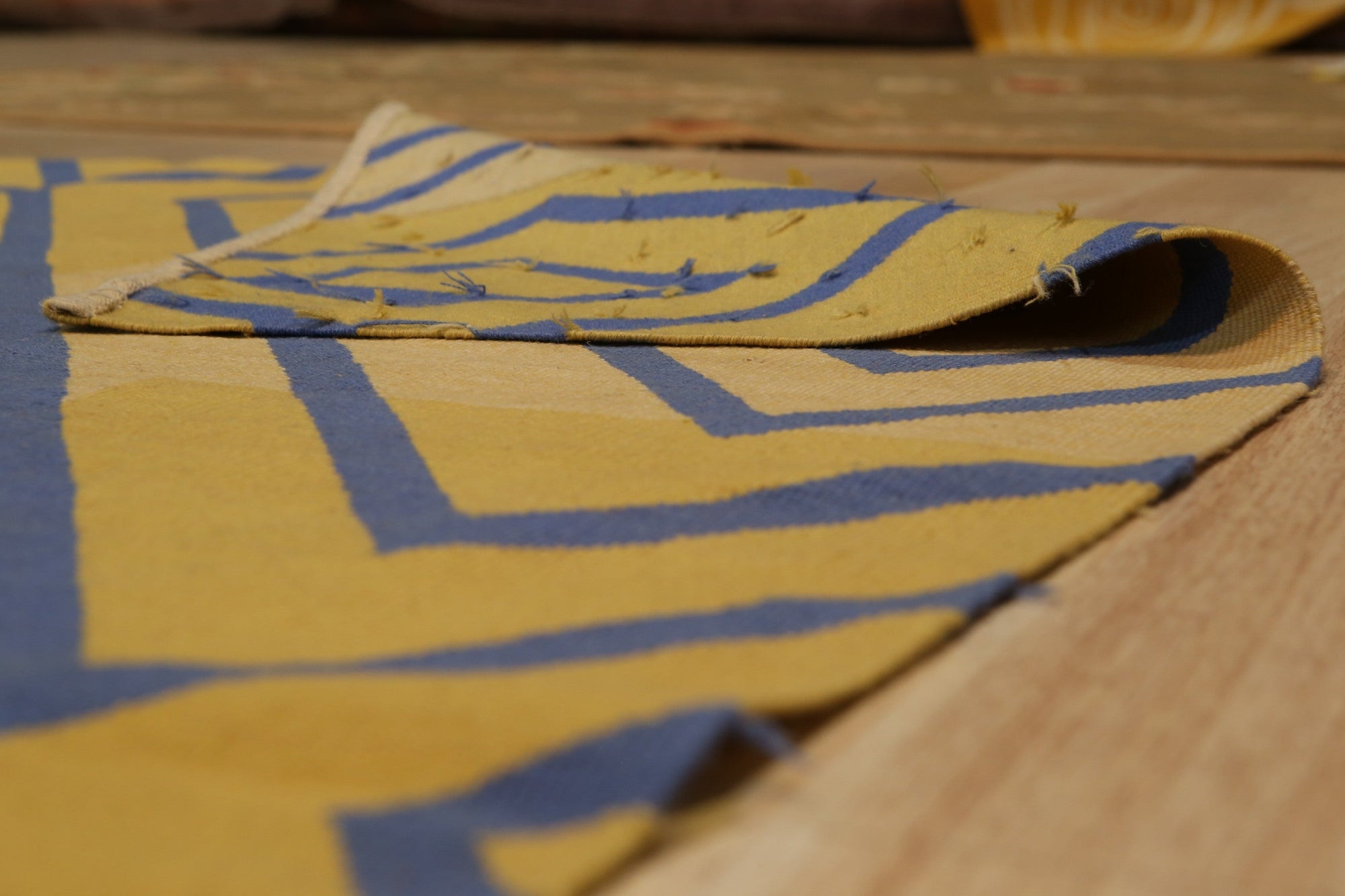 Timeless Beautiful Yellow Flatweave Wool Rug, a warm yellow flatweave rug, adds a touch of sunshine to a bright, modern living space with a neutral sofa and minimalist decor.