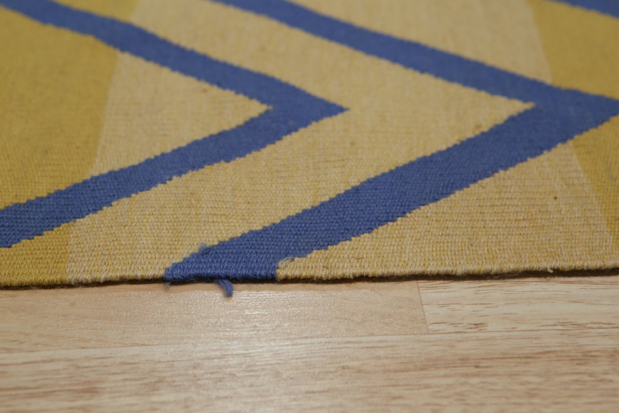 Timeless Beautiful Yellow Flatweave Wool Rug, showcasing its sunny disposition in a bright, minimalist living room. The rug's flatweave construction and warm yellow hue anchor the space, complemented by neutral furniture and vibrant greenery.