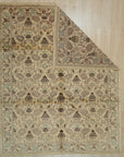 Vibrant Chloe Ivory Hand Knotted Wool Rug, showcasing intricate floral patterns and geometric borders in soft ivory hues, sits elegantly within a brightly lit living room setting.
