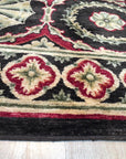 Giselle Violet Red Hand Knotted Wool Rug, a vibrant interplay of violet and red hues woven in wool, features a hand-knotted construction seen in a modern living space.