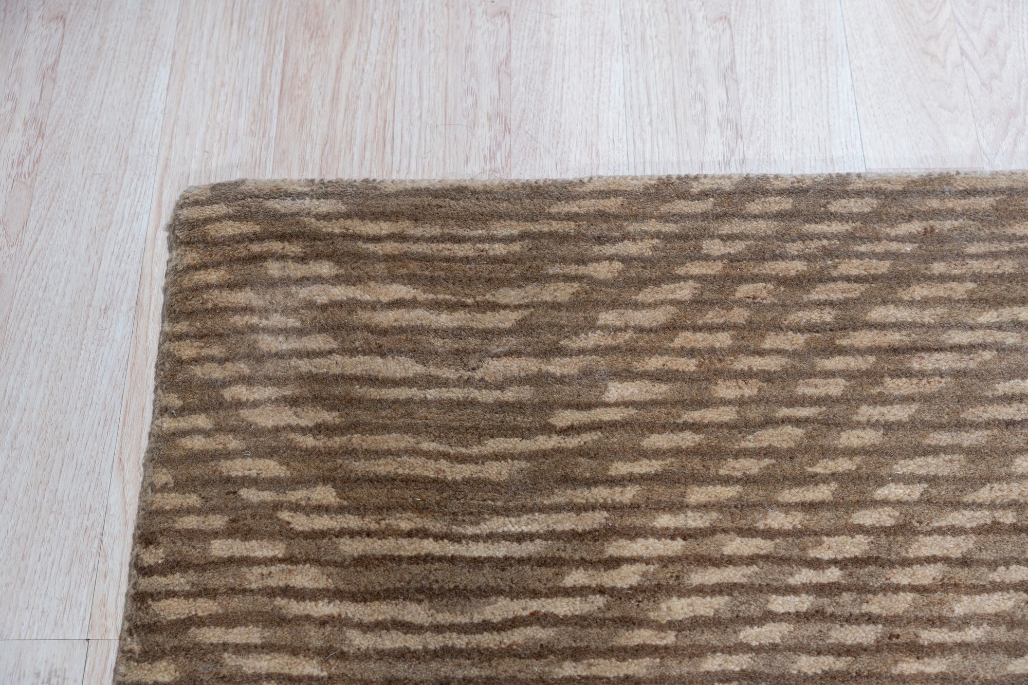 Sloane Freya Brown Hand Tufted Wool Rug, textural waves of deep brown and creamy beige ripple across this hand-tufted wool rug, adding warmth and organic modern style to a living space.