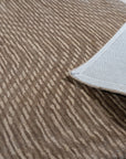 Sloane Freya Brown Hand Tufted Wool Rug, showcasing a textured, neutral palette in a cozy living room setting, highlighting its warm brown tones and handcrafted wool construction.