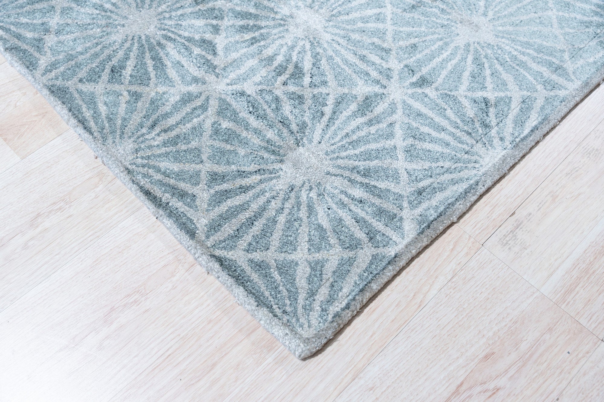 Versatile Yara Ivory Hand Tufted Wool Rug, showcasing a neutral palette and subtle texture in a brightly lit living space.