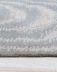 Graceful Captivating Gray Hand Tufted Wool Rug, a soft gray wool rug with a subtle pattern, displayed in a well-lit living room setting.