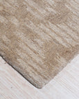 Vibrant Alluring Beige Hand Tufted Wool Rug, displaying its plush texture and subtle beige hues, complements a contemporary living space with light wood flooring and minimalist decor.