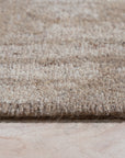 Vibrant Alluring Beige Hand Tufted Wool Rug, soft beige textures meet modern design in a living room setting; its wool pile inviting bare feet and effortless style.