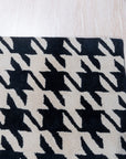 Inviting Timeless Black, White Hand Tufted Wool Rug, its graphic black and white design grounding a bright living space with textured comfort.