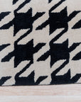 Inviting Timeless Black, White Hand Tufted Wool Rug, a black and white wool rug with a geometric design, complementing a modern living room.
