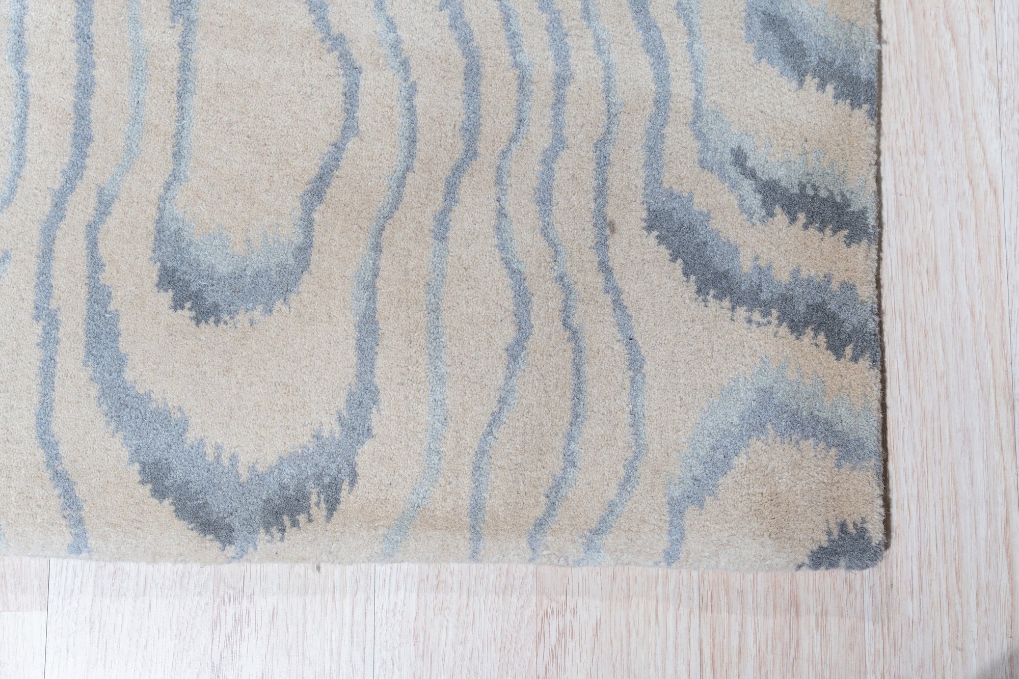 Vibrant Dahlia Beige Hand Tufted Wool Rug, a beige wool rug with a floral dahlia design, seen in a living room setting showcasing furniture pairing options.