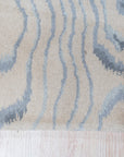 Vibrant Dahlia Beige Hand Tufted Wool Rug, a beige wool rug with a floral dahlia design, seen in a living room setting showcasing furniture pairing options.