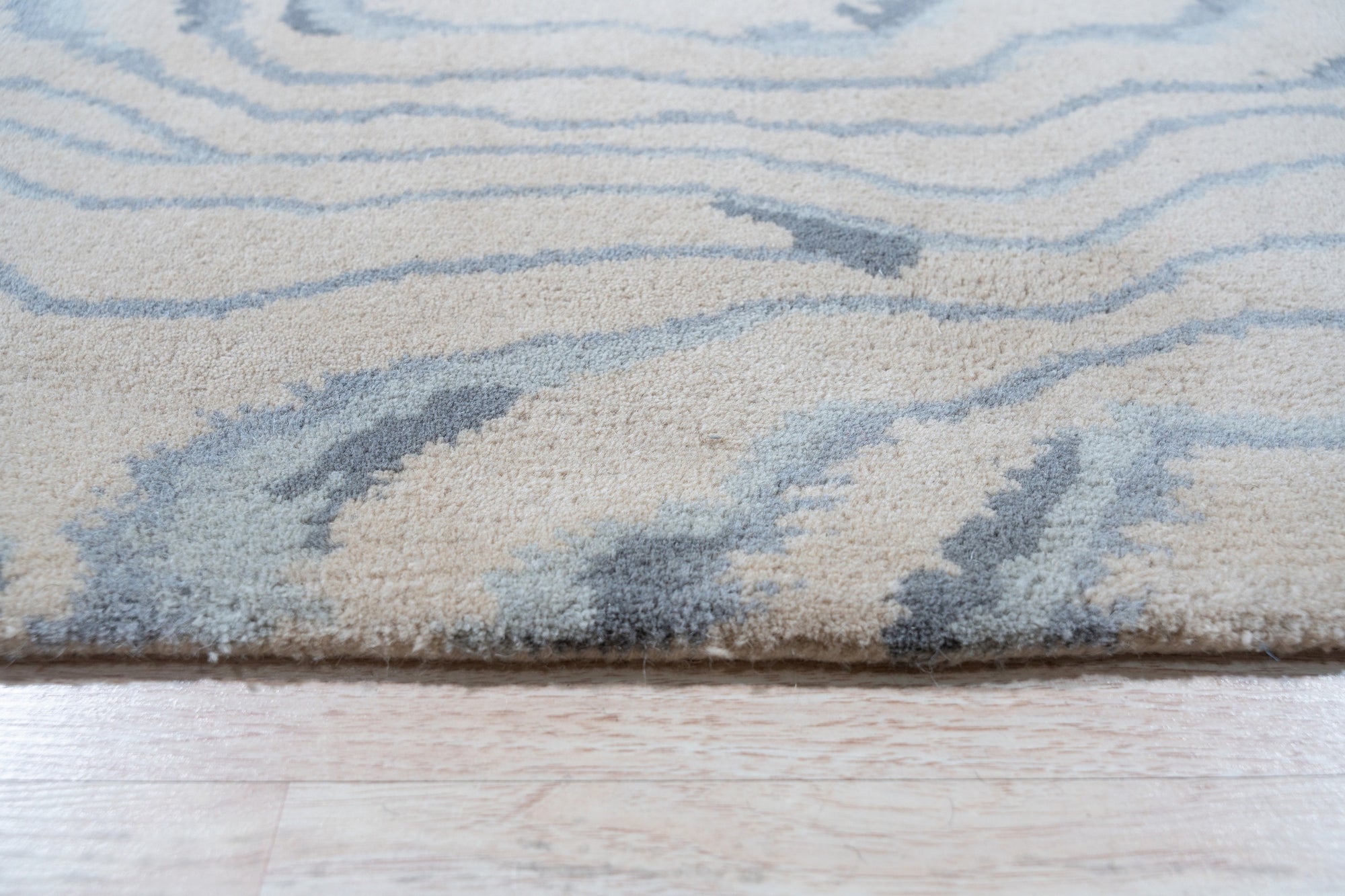 Vibrant Dahlia Beige Hand Tufted Wool Rug, showcasing intricate floral patterns in beige, cream, and subtle earth tones, bringing warmth and texture to a living space. Hand-tufted wool construction adds luxurious comfort and durability.