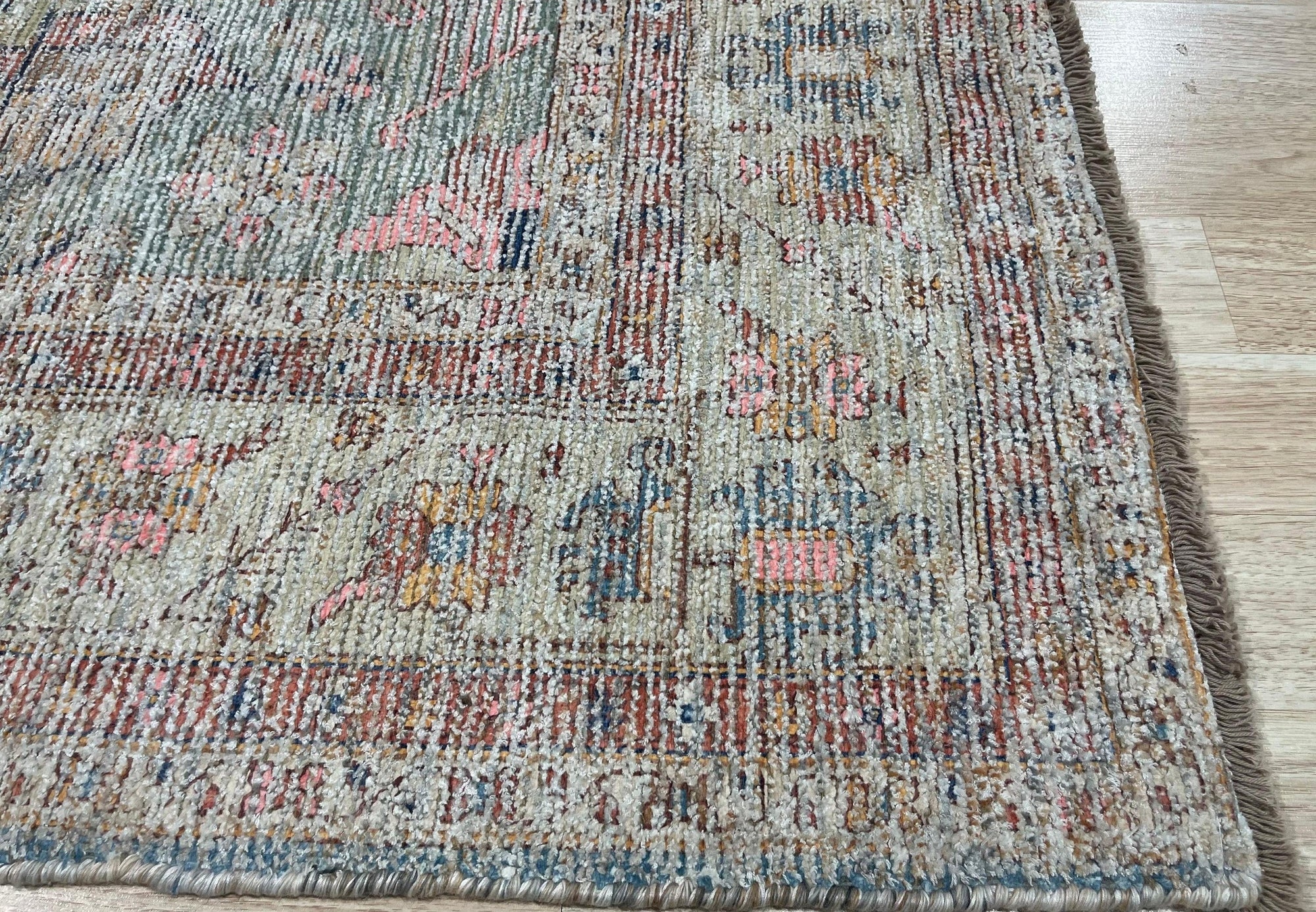 Fiona Vibrant Ivory Handmade Wool Rug displayed in a bright, airy living room. Ivory tones and handcrafted wool texture provide warmth underfoot. Geometric patterns add modern flair to the cozy space.