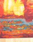 Bianca Isla Red Machine Made Rug displayed in a bright living space, its vibrant red hues and intricate pattern adding warmth and texture to the room.