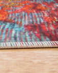 Bianca Isla Red Machine Made Rug, displays a vibrant geometric pattern in shades of red, cream, and brown, creating a warm and inviting atmosphere on hardwood floors.