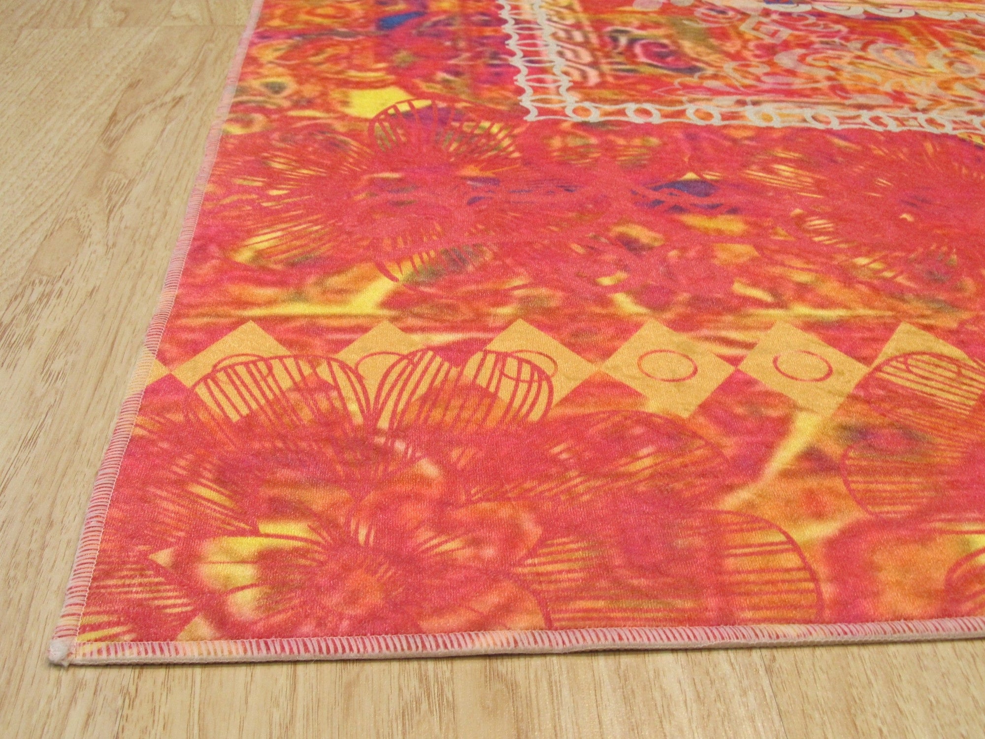 Xena Artistic Multicolor Machine Made Rug, vibrant abstract patterns in shades of blue, orange, and cream create a modern focal point in a bright living room setting.