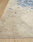 Modern Classic Blue Machine Made Rug featuring swirling patterns of navy and cream, lying flat on a light-colored floor, inviting comfort and elegance into any space.