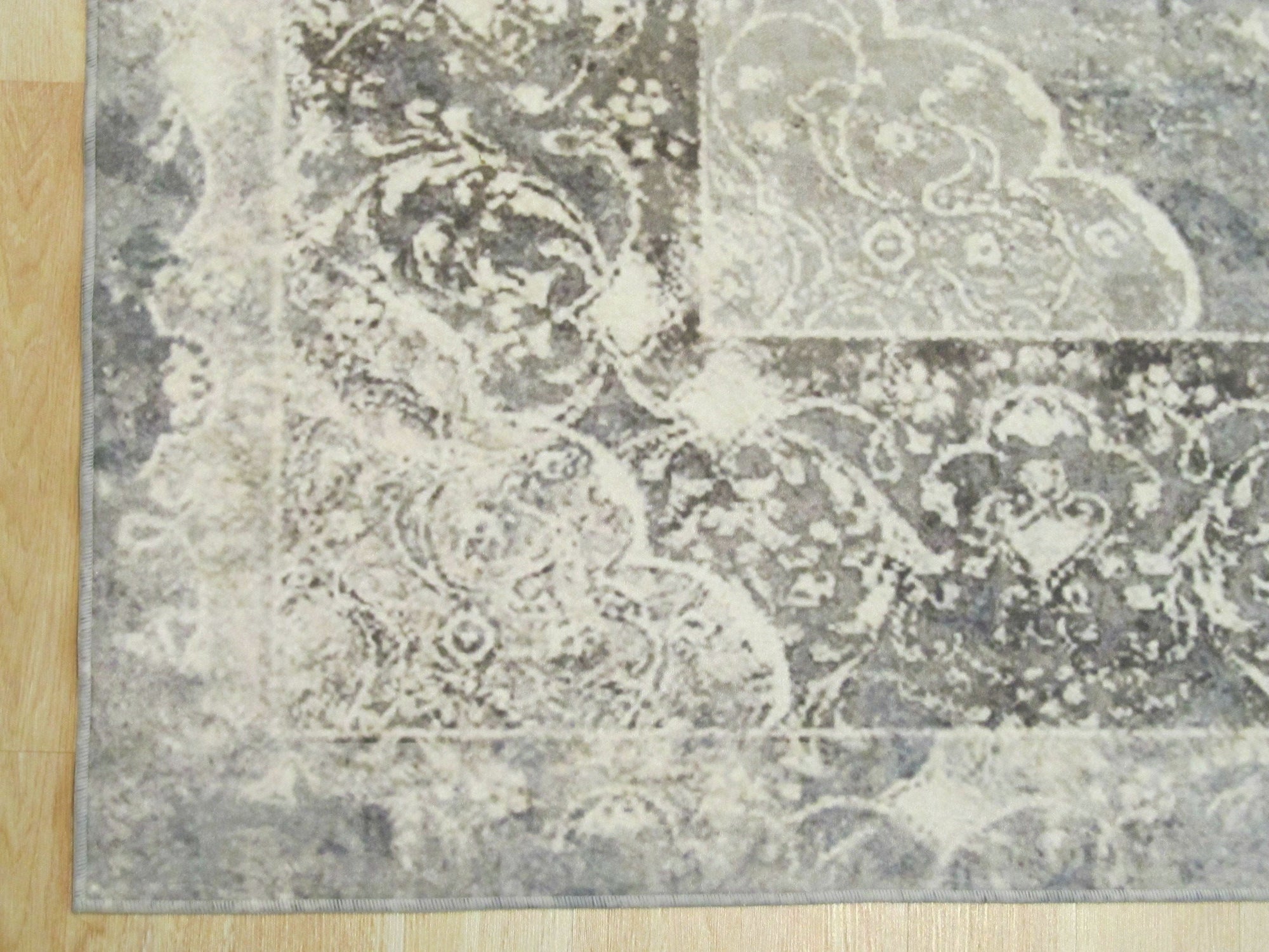 Bianca Warm Gray Machine Made Rug, anchoring a minimalist living room with its subtle warmth; soft gray tones blend effortlessly, offering a plush, inviting feel underfoot.