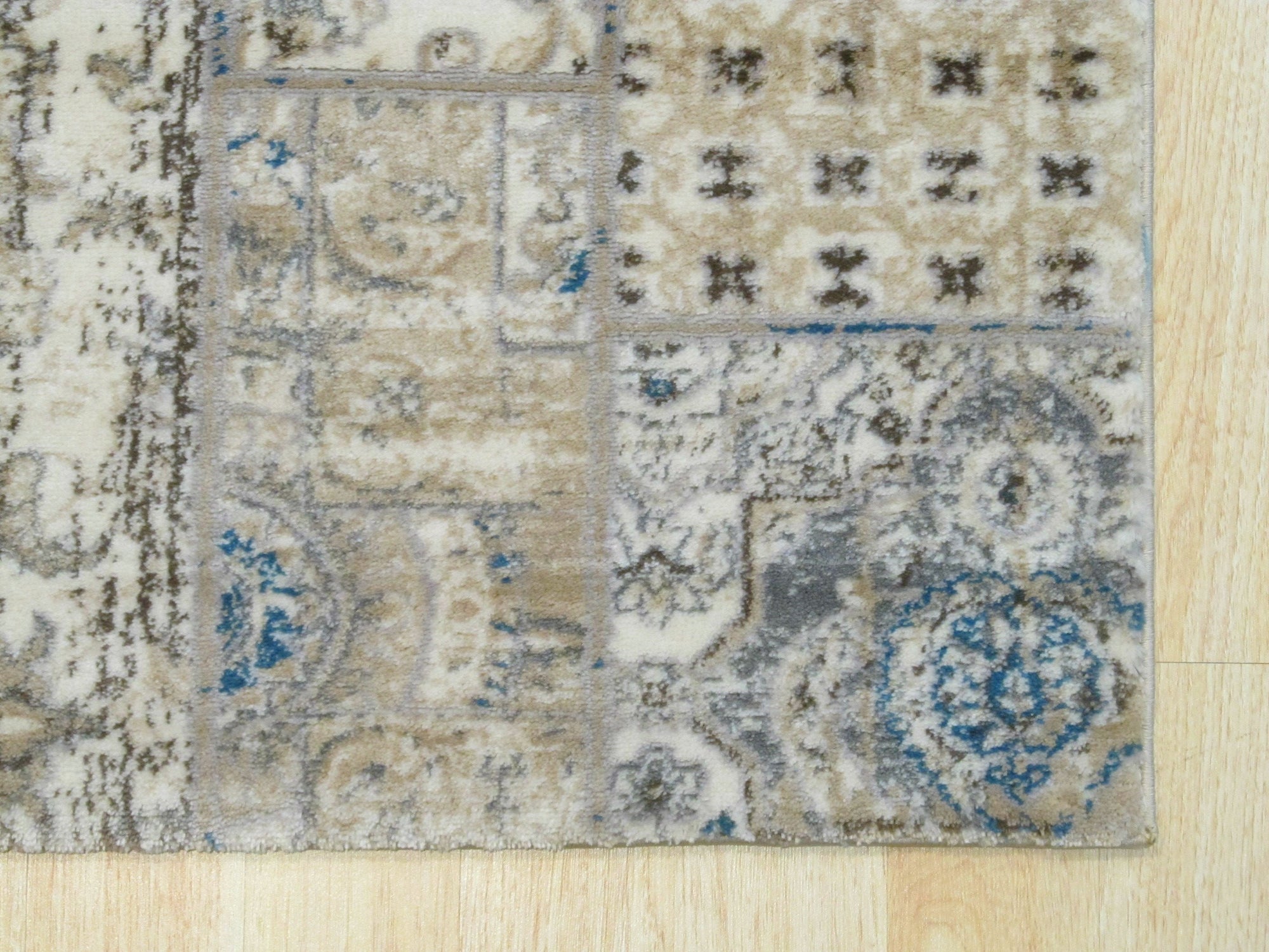 Sarrah Para Ivory Machine Made Rug, blending seamlessly with a light wood floor, showcasing intricate floral patterns and a soft, muted ivory palette within a bright, modern living space.