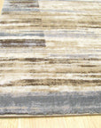 Enchanting Cassandra Ivory Machine-Made Rug, ivory and machine-made with a distressed, vintage-inspired pattern, nestled under a modern coffee table in a bright living room.