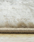 Sophisticated Willow Ivory Machine Made Rug graces a living room; its soft ivory tones complement the room's neutral palette, creating a serene and inviting space.