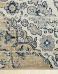 Iris Mira Ivory Machine Made Rug, its soft ivory tones and subtle floral-inspired design blending seamlessly into a bright living room; a glimpse of woven texture adds depth and warmth to the space.