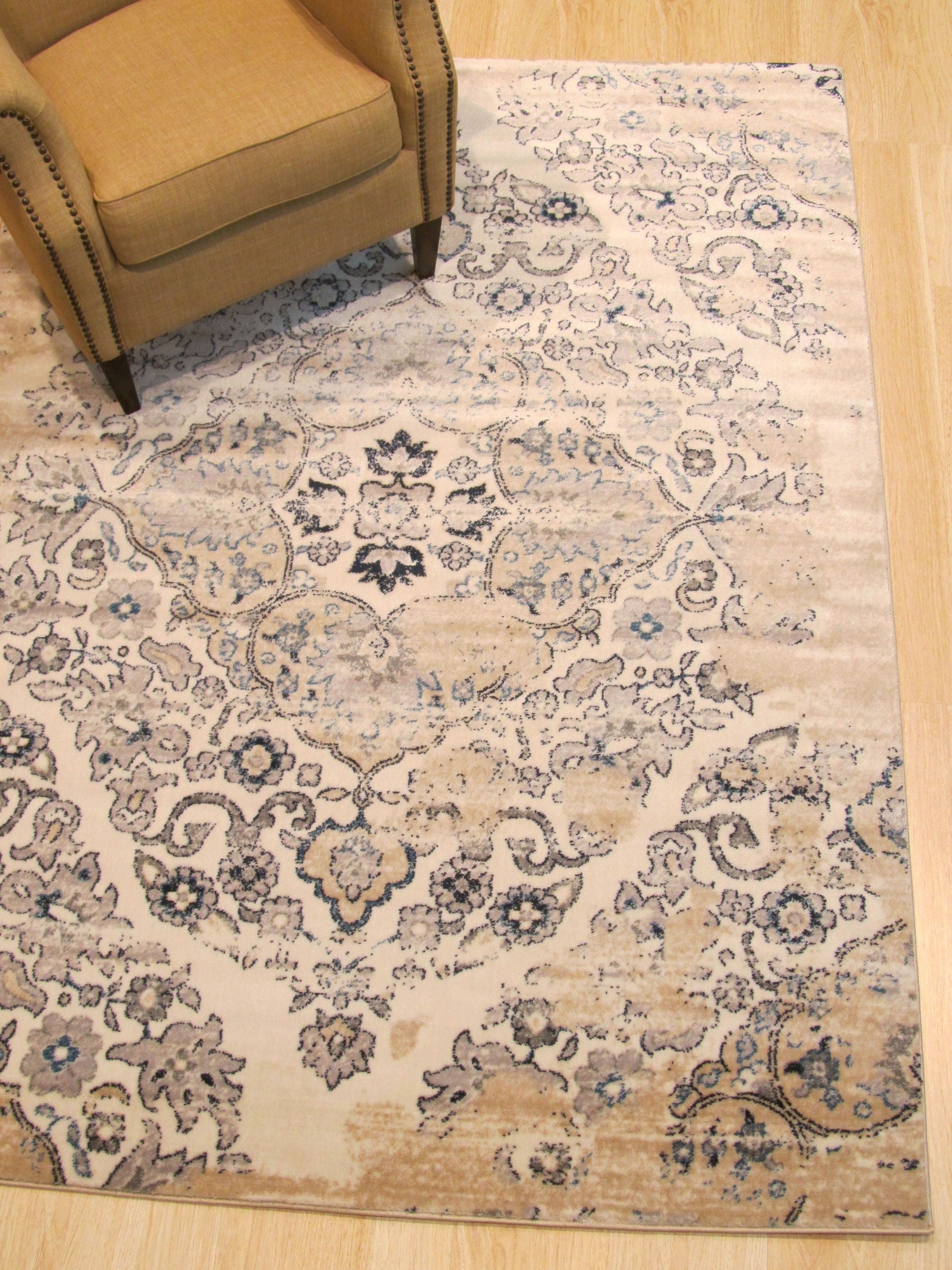 Iris Mira Ivory Machine Made Rug displayed in a bright, contemporary living space. Soft ivory tones and subtle textures of this machine-made rug complement the modern furniture and create a welcoming atmosphere.