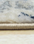 Iris Mira Ivory Machine Made Rug, showcasing its ivory hues and intricate floral pattern laid on a light hardwood floor, adding warmth and elegance to a bright, airy living space.
