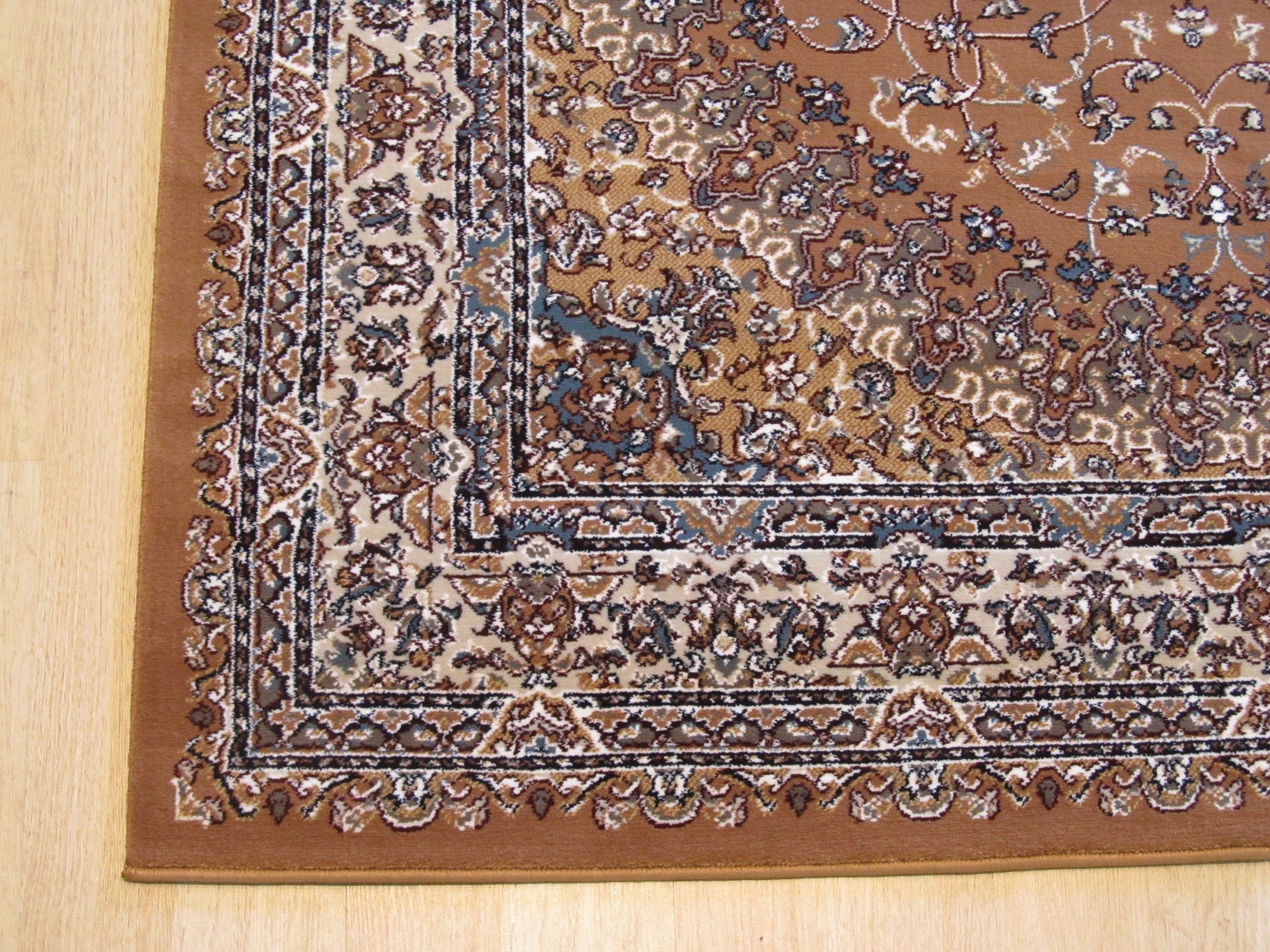 Iris Opulent Rust Machine Made Rug, showcasing a detailed floral pattern in rich rust tones, machine-made construction visible in the tight weave, covering a portion of a warmly lit room.