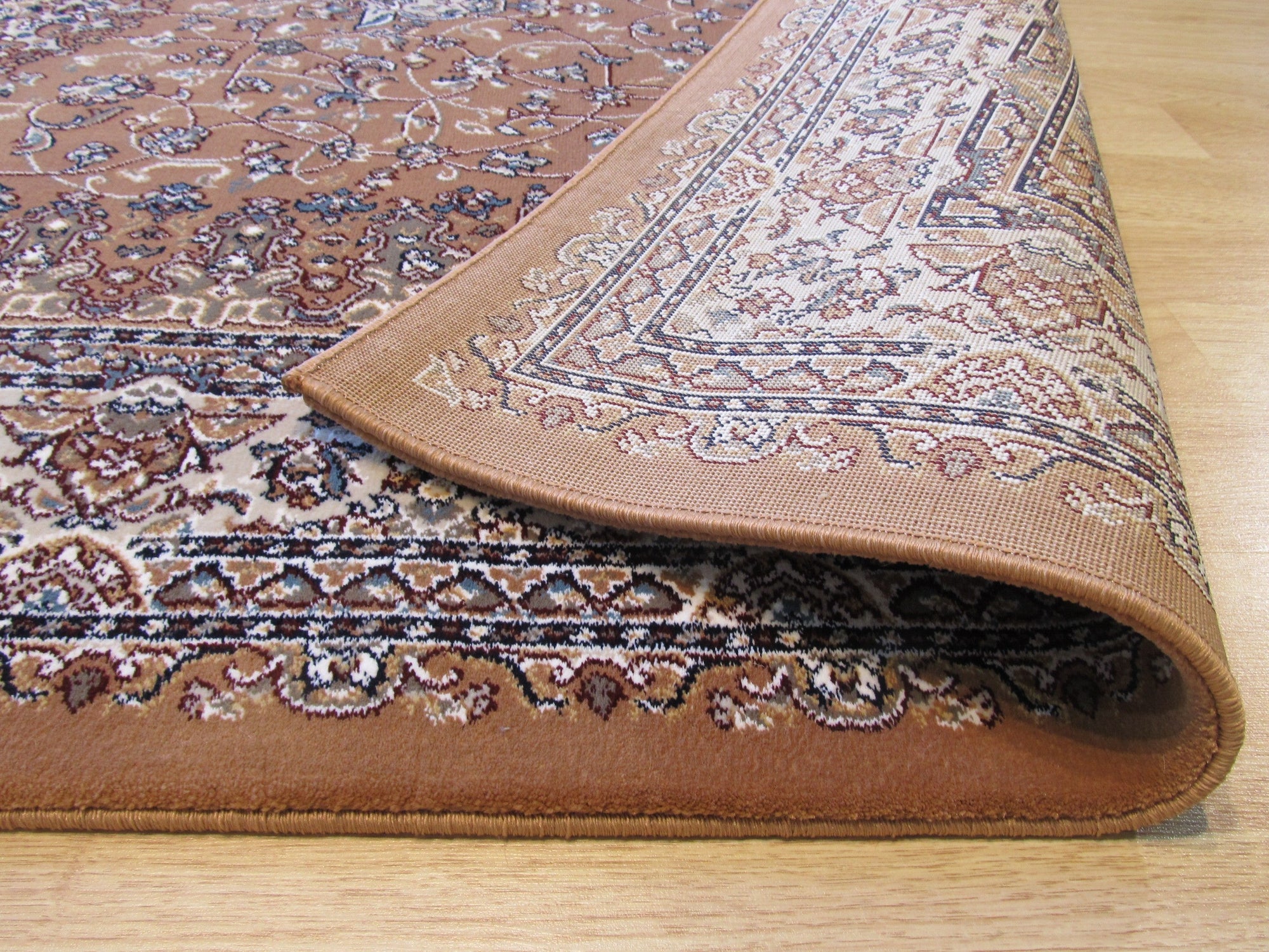 Iris Opulent Rust Machine Made Rug, seen in a living room setting, featuring a vibrant rust-colored palette and a swirling, opulent design.