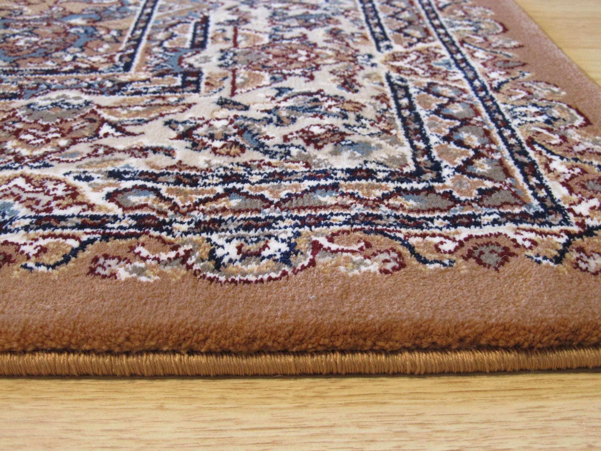 Iris Opulent Rust Machine Made Rug, featuring a complex floral pattern in warm rust tones, sprawls across a light wood floor, suggesting a cozy and inviting living space.