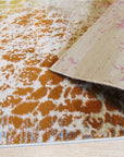 Brenda Lydia Ivory Machine Made Rug, showcasing a living room setting with a light-toned, machine-made rug featuring a subtle, geometric pattern under a coffee table, creating a warm and inviting atmosphere.