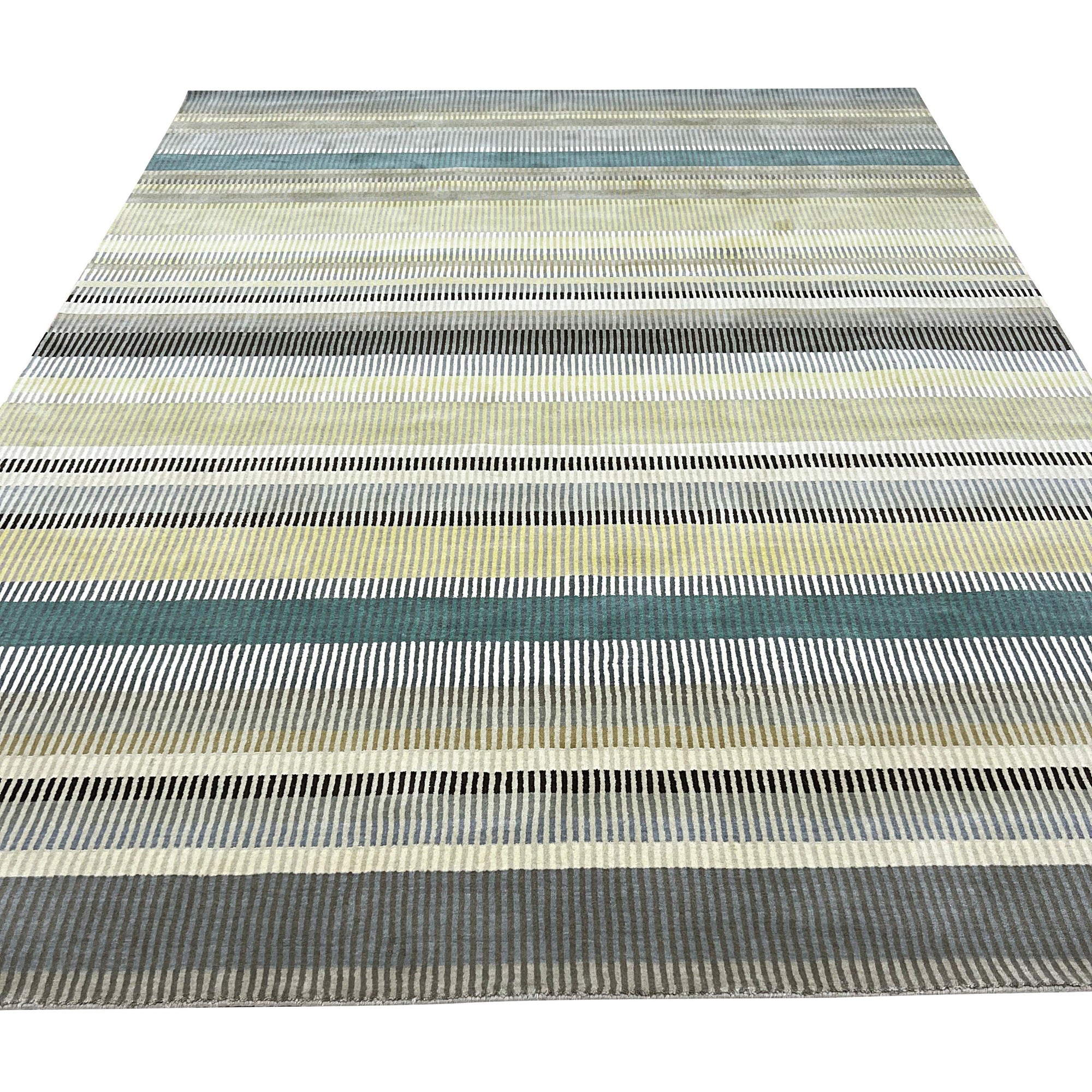 Zinnia Striped Green Handmade Wool Rug, vibrant green and cream stripes alternating across a handwoven wool texture, evokes a fresh, contemporary feel in a bright, sunlit room.