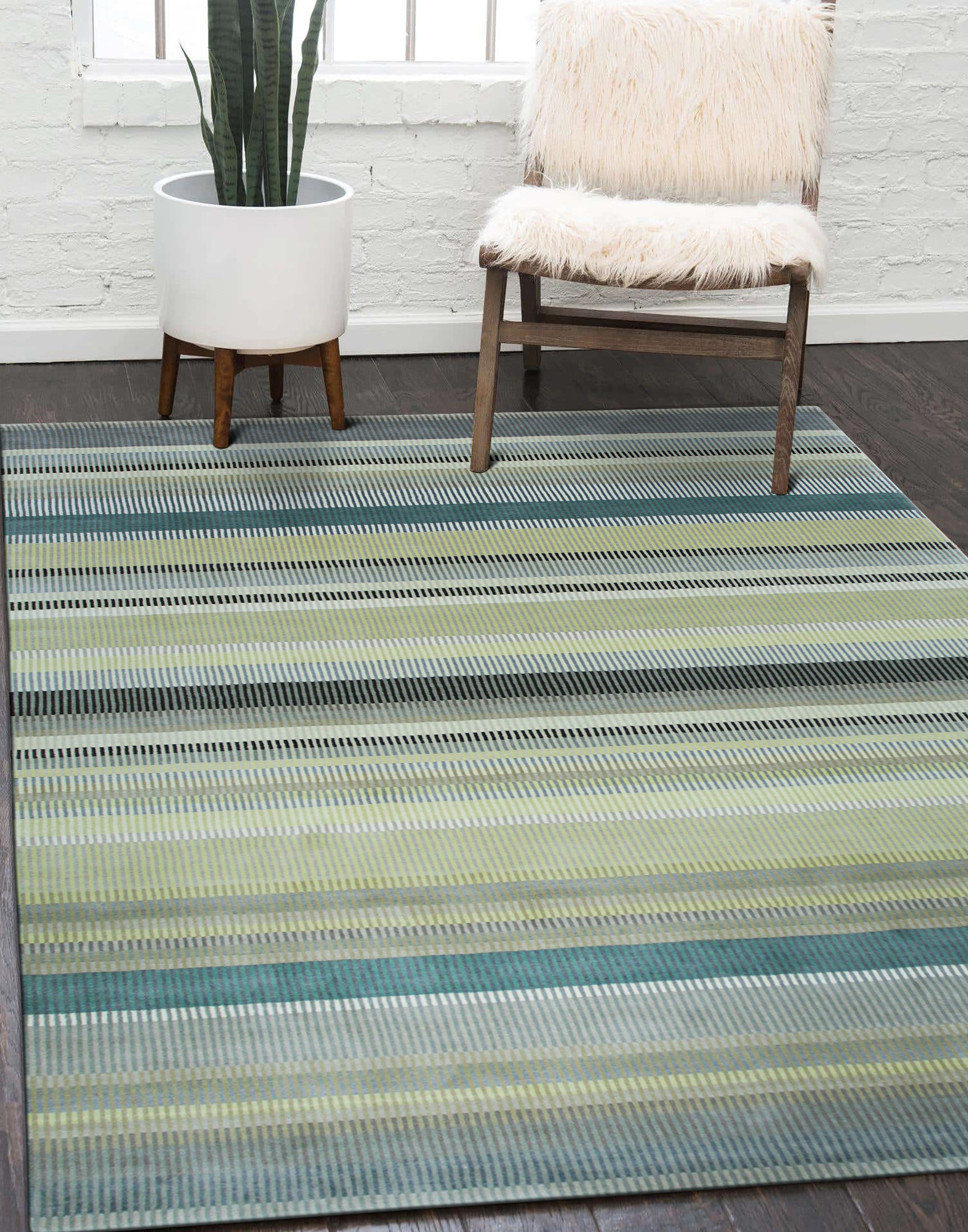 Zinnia Striped Green Handmade Wool Rug, vibrant green stripes dance across a hand-knotted wool rug, adding warmth and texture to a light-filled living space.