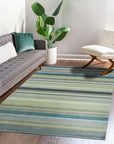 Zinnia Striped Green Handmade Wool Rug graces a living room, its vibrant green stripes energizing the space. Handcrafted wool offers soft texture and durable warmth beneath a modern coffee table.