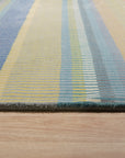 Serene Xena Green Handmade Wool Rug, showcasing its calming green tones and textured wool construction in a bright, modern living room setting with light wood floors.