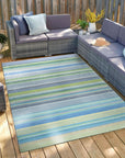 Serene Xena Green Handmade Wool Rug, displaying its lush green tones and intricate handwoven texture, anchoring a bright living room with natural light and complementing modern furniture.