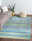 Serene Xena Green Handmade Wool Rug, a lush green wool rug with a subtle geometric pattern, displayed on a polished hardwood floor with natural light highlighting its texture.